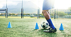 Legs, soccer and man with cone for sports, game practice or running drills for training on field. Football player, feet and person with equipment for agile exercise, fitness challenge or ball control