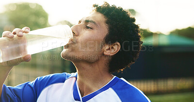 Buy stock photo Sports, soccer and man outdoor for drinking water, hydration and wellness after training for game. Football field, male person and player on break with h2o liquid, practice and beverage for thirst