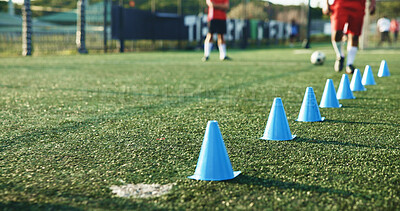 Buy stock photo Field, soccer and cone for sports, game practice or drills for training with team at stadium. Football player, legs or people with equipment for agile formation, fitness challenge or exercise outdoor