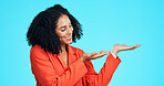 Business, woman and gesture in studio for presentation, advertising launch and job interview. Smile, female person and icon for announcement, corporate hiring and onboarding offer on blue background