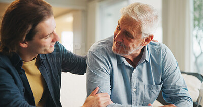 Buy stock photo Support, home and senior father with man for conversation, connection and bonding together on weekend. Elderly dad, son or talking on sofa with parent for trust, smile and comfort in living room