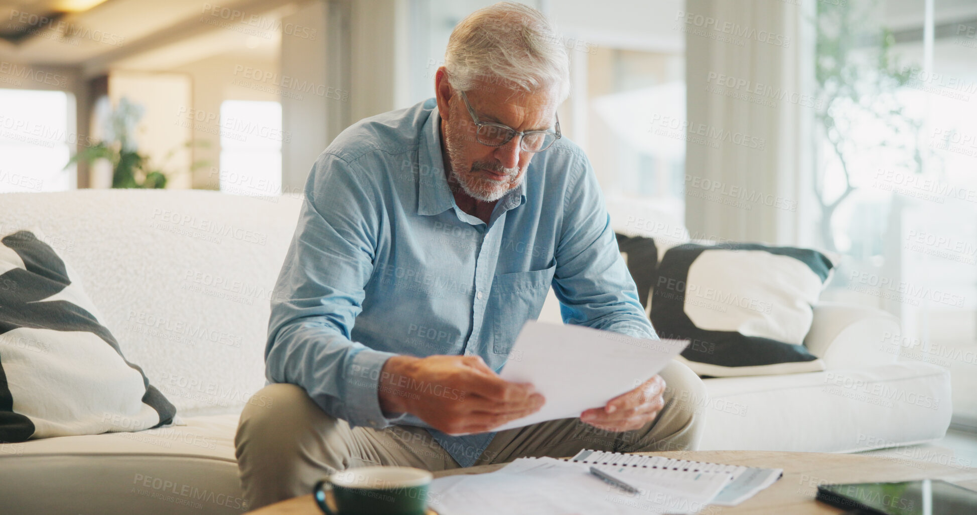 Buy stock photo Reading, documents and senior man on sofa with planning for insurance, retirement or assets in home. Policy, pension letter and person with paperwork for financial investment, savings or mortgage