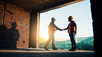 Meeting, construction and men with handshake in building for agreement, compliance and partnership. Team, architecture and people shaking hands for renovation project, infrastructure and development