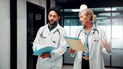 Buy stock photo Meeting, walking and doctors with paperwork in hospital for planning, patient diagnosis and advice. Healthcare, clinic and man with woman with report for consulting, treatment and medical service