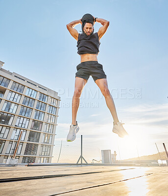 Buy stock photo Athlete, man or jump with medicine ball outdoor for fitness, cardio exercise or power training. Sunshine, below of person or leap with equipment for wellness, strength workout or endurance challenge