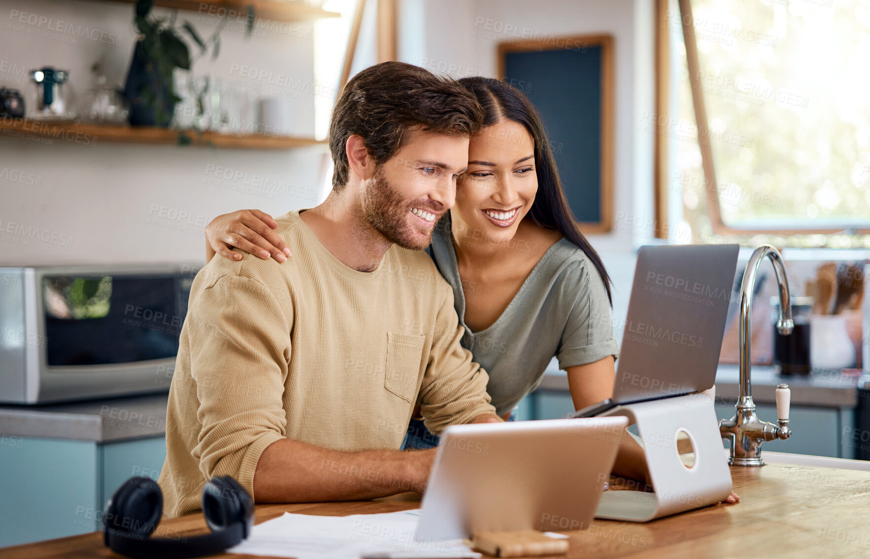 Buy stock photo Smile, couple and reading with laptop in kitchen for research, finance report and banking. Happy, people and embrace with pc for mortgage, household budget and investment for savings account in home