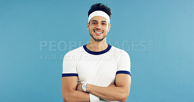 Buy stock photo Arms crossed, portrait and tennis with man on studio space for health, retro sports or wellness. Confidence, fitness and smile with person on blue background for competition, game or hobby as player