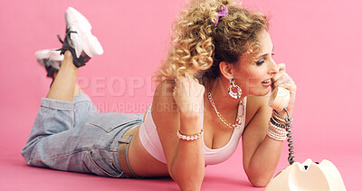 Buy stock photo Fashion, telephone and woman in studio for phone call, communication or relax with retro outfit. Happy, chat and person with landline for gossip conversation with vintage style by pink background.