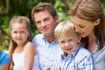 Buy stock photo Parents, children and smile in nature with love, bonding and relationship care on summer holiday. Mom, dad and outdoor with portrait of boy for family support, relax and connection with development
