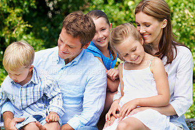 Buy stock photo Happy, parents and relax with children at park for love, parental support and bonding together. Smile, people and kids for affection, admiration and family connection on vacation getaway in nature
