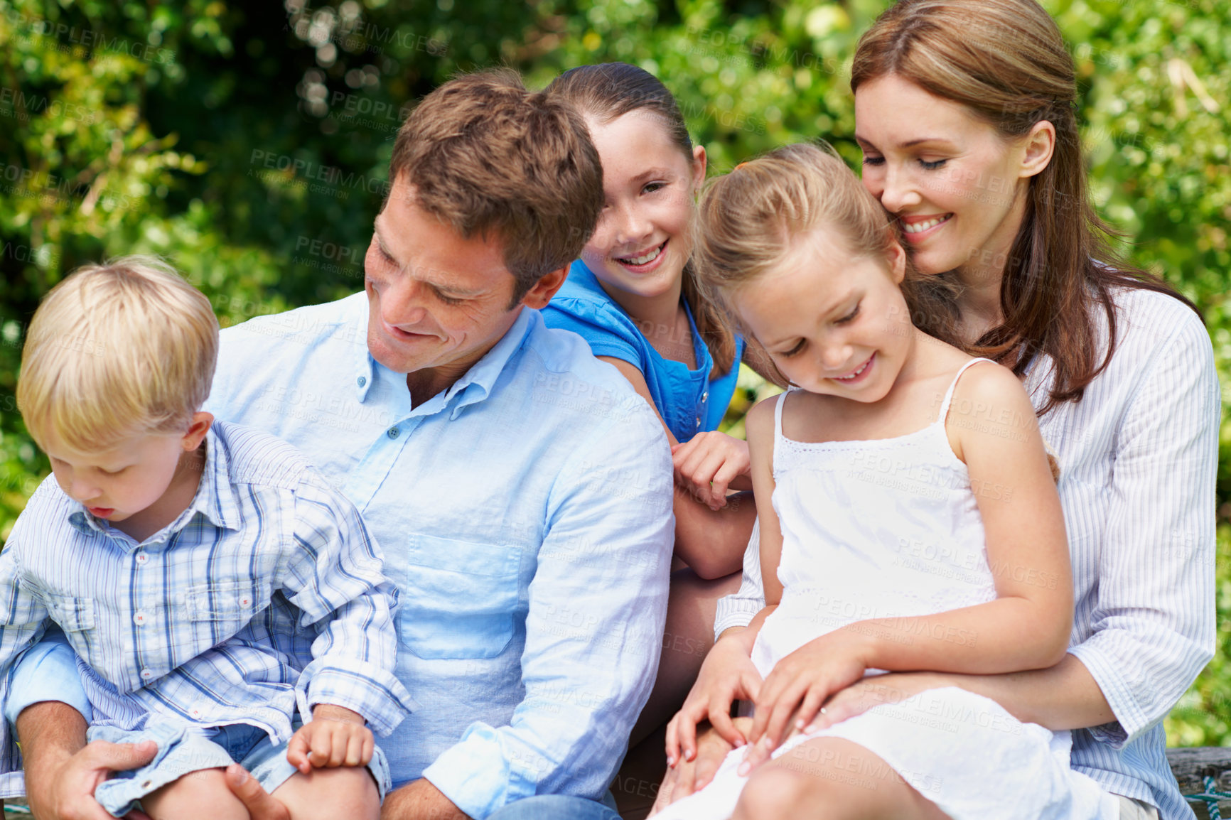 Buy stock photo Happy, love and family in nature at park with conversation, bonding and weekend break together. Smile, care and children with mother and father with talking for connection outdoor in backyard.