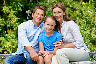 Buy stock photo Parents, child and happy portrait at park for bonding together, holiday trip and relationship. Love, people and girl with smile in nature for family outing, connection and support on weekend getaway
