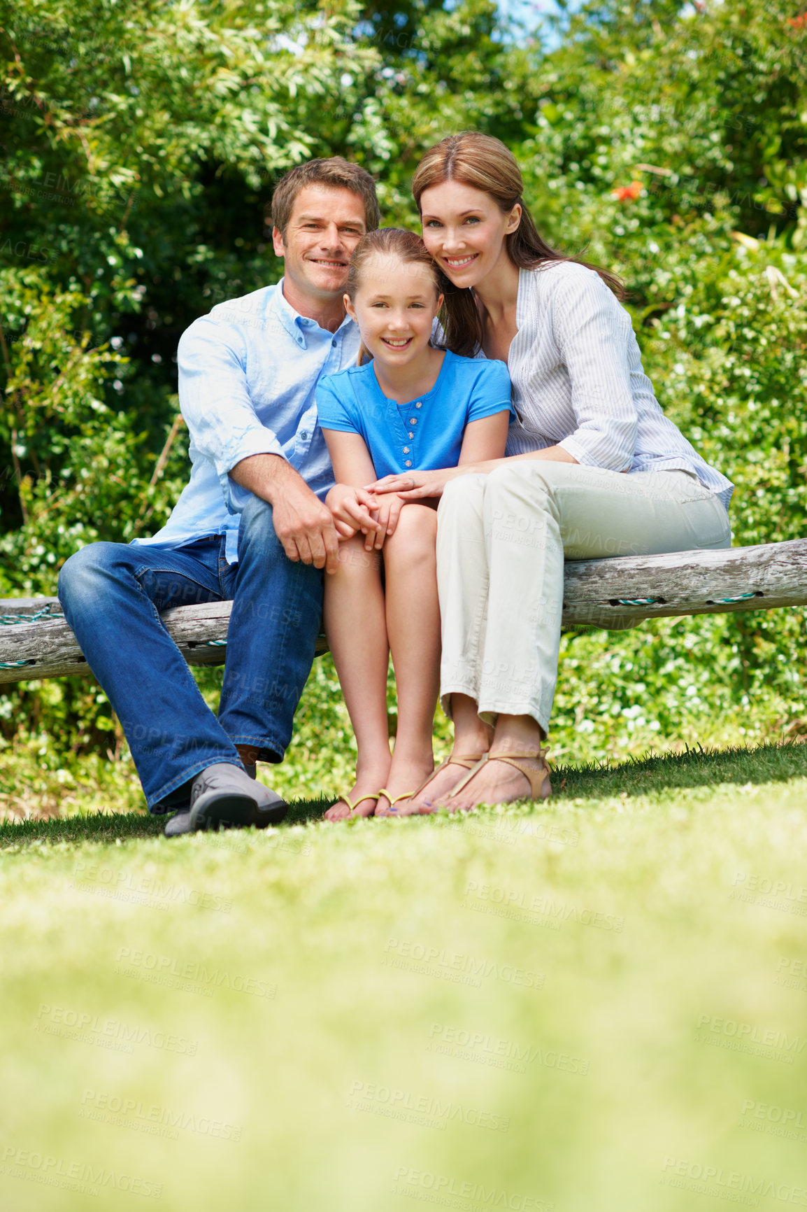 Buy stock photo Happy, parents and relax with child at park for love, affection and bonding together on holiday. Portrait, people and daughter for compassion, family connection and vacation getaway in countryside