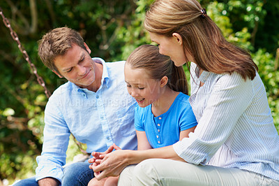 Buy stock photo Break, love and summer with family outdoor in backyard together for bonding or conversation. Daughter, parents and relax on swing with happy people in garden for development or relationship security