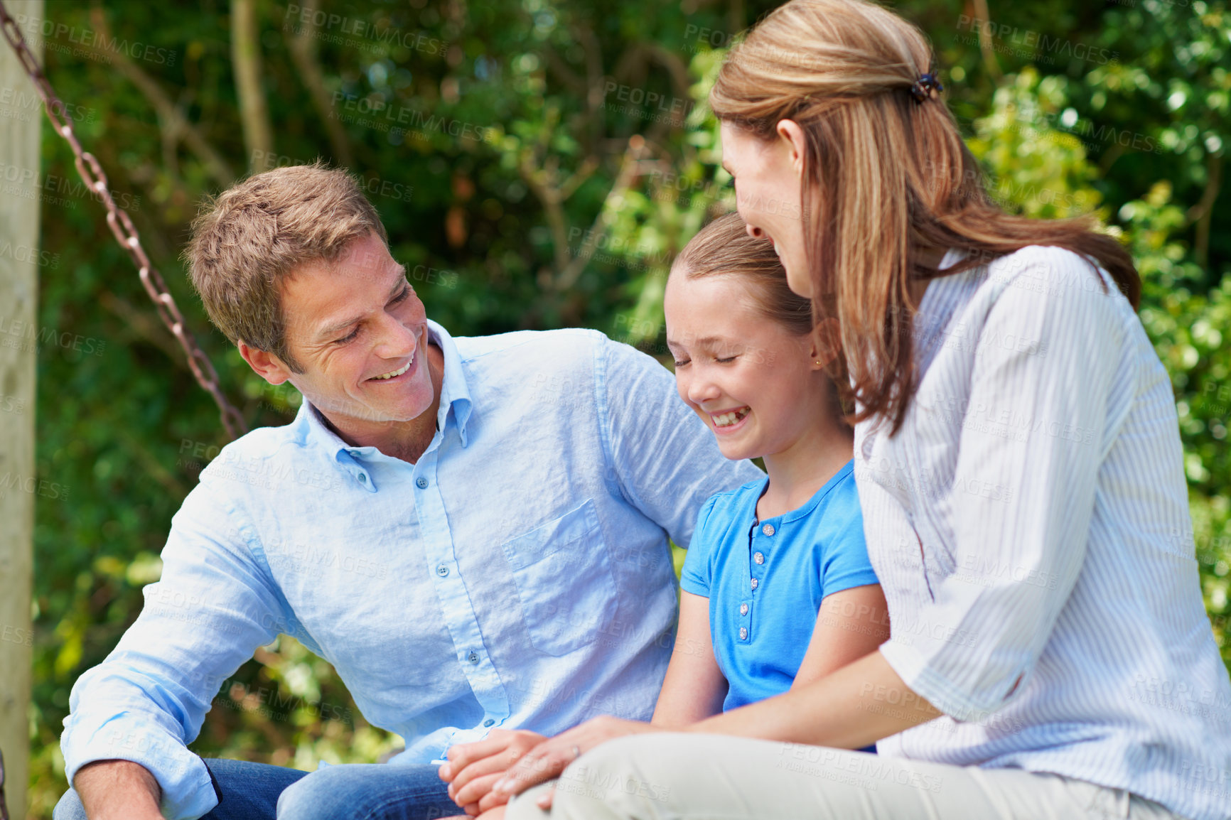 Buy stock photo Happy, parents and relax with daughter at park for love, parental support and bonding together. People, laughing and swing with child, admiration and family connection on vacation getaway in nature