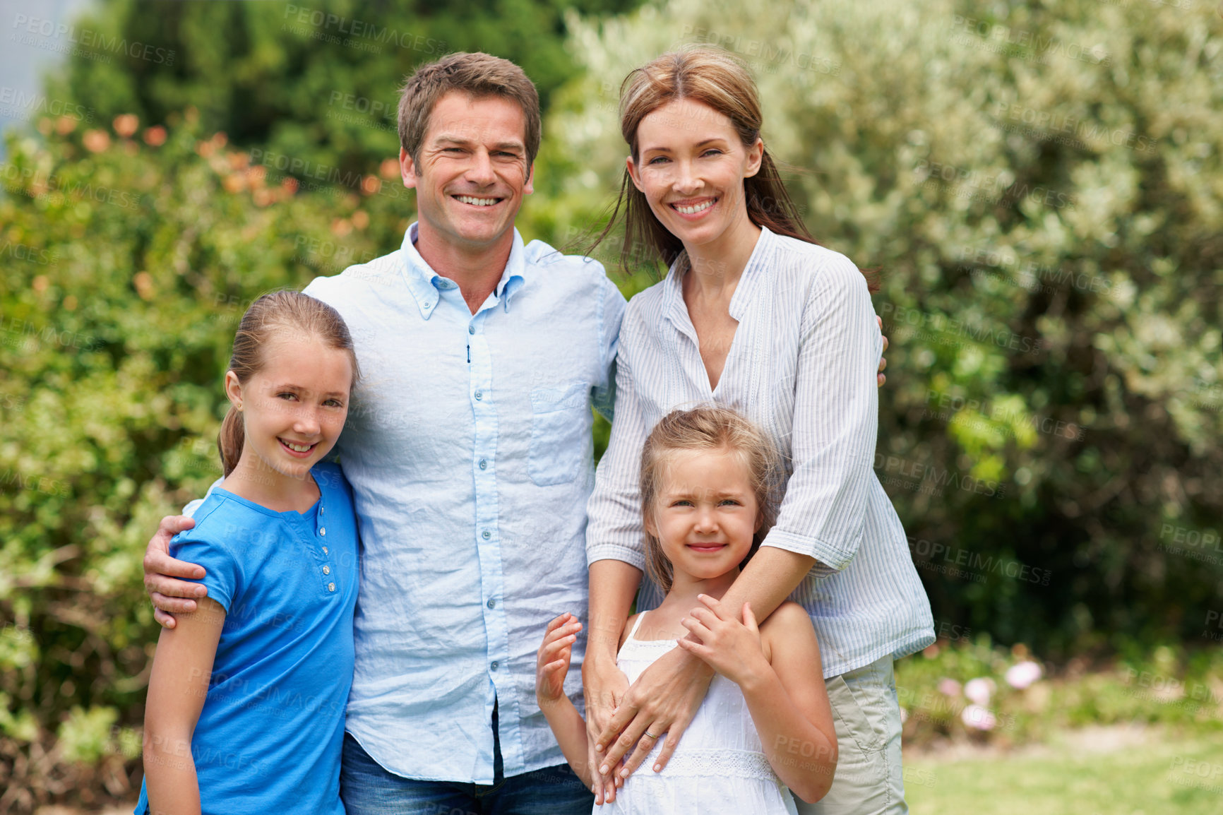 Buy stock photo Portrait, parents and smile with children in nature for love, parent support and bonding together. Happy, people and affection with kids, family connection and weekend break on vacation trip outdoor