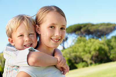 Buy stock photo Siblings, kids and piggyback portrait at park for bonding together, relationship and playing. Happy children, sister and carry brother in nature for affection, love connection and support on weekend