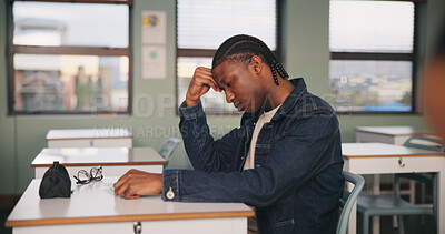 Buy stock photo School, bored and tired black man in classroom for lesson, learning and studying at desk. Stress, college and person with fatigue, student or exhausted for test, exam or education for assignment