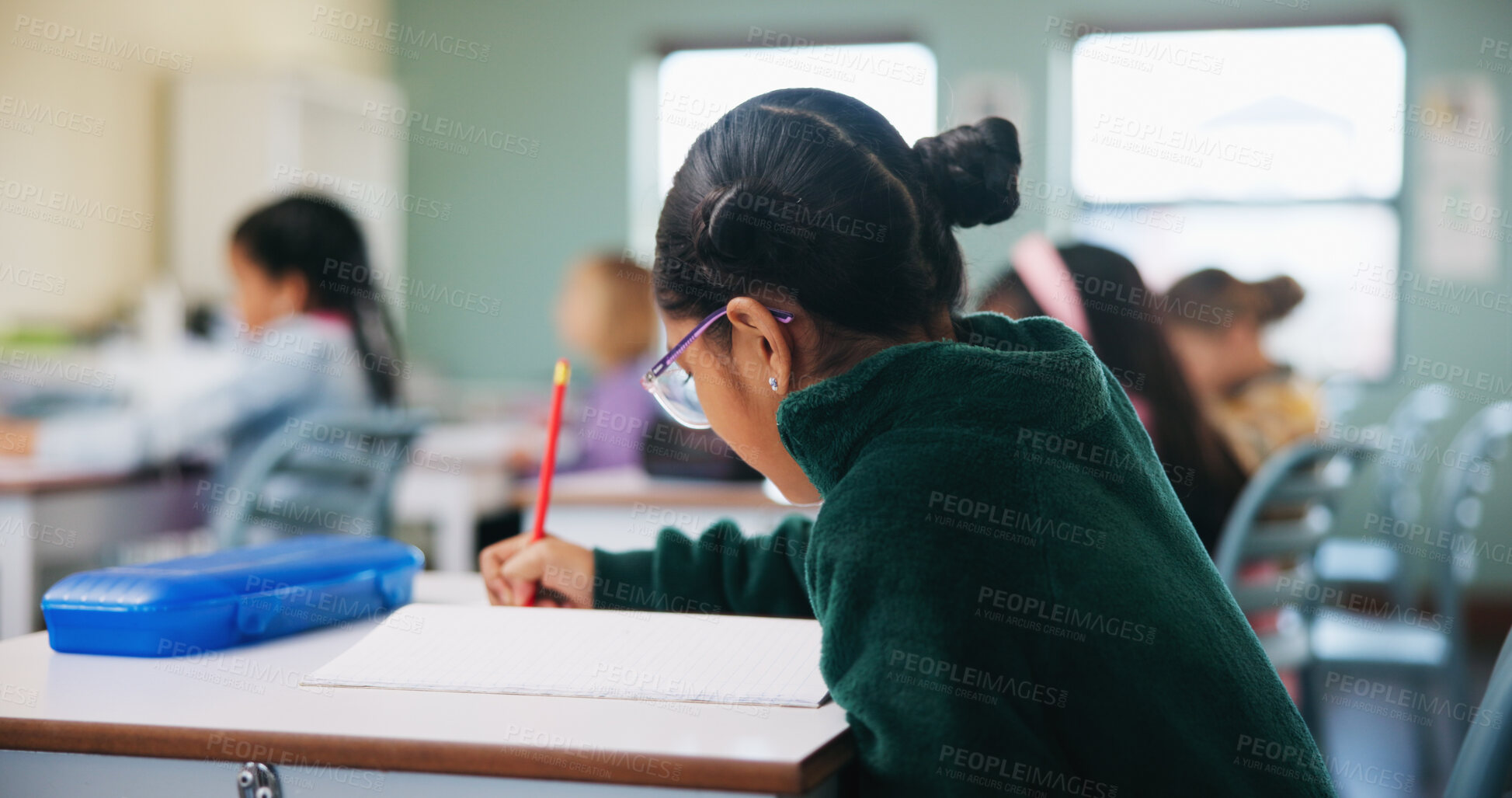 Buy stock photo Education, kid and writing test in classroom for assessment, quiz and development with student. School, girl child and book for exam at elementary, learning or study knowledge with course in lesson