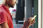 African American using smart phone in busy city to stay connected using social media