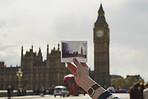 Hand holding polaroid instant camera film of famous Big Ben London city nostalgia memory 