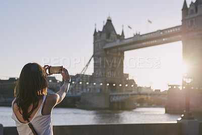 Buy stock photo Outdoor, picture and woman with phone screen on holiday, sightseeing and memory on social media post. Tourism, photography and person with mobile on vacation, back and sharing travel blog on website