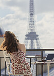 Travel woman enjoying view Eiffel Tower Paris hotel terrace breakfast destination vacation laptop camera