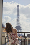 Travel woman enjoying view Eiffel Tower Paris hotel terrace breakfast destination vacation laptop camera
