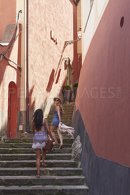 Buy stock photo Buildings, travel and walk with friends on old city steps for European break, holiday or vacation. Adventure, back and stairs with tourist women outdoor in small town to discover or explore culture