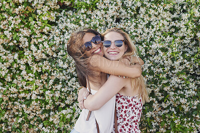 Buy stock photo Friends, hug and women with smile for reunion, flower background and bonding on weekend or together. Happy people, portrait and laughing with sunglasses on break, hangout and affection with embrace
