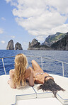 beautiful girl friends on speed boat having fun in bikini on travel adventure in Italy wanderlust