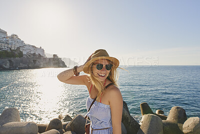 Buy stock photo Happy, woman and hat by ocean with summer holiday, sunglasses and tropical getaway on weekend break. Space, person smile and outdoor by sea with shades, travel vacation and wellness for tourist trip.
