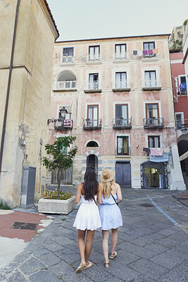 Buy stock photo Buildings, travel and walking with friends in old city for European break, holiday or vacation. Adventure, journey and tourism with back of women outdoor in small town to discover or explore culture