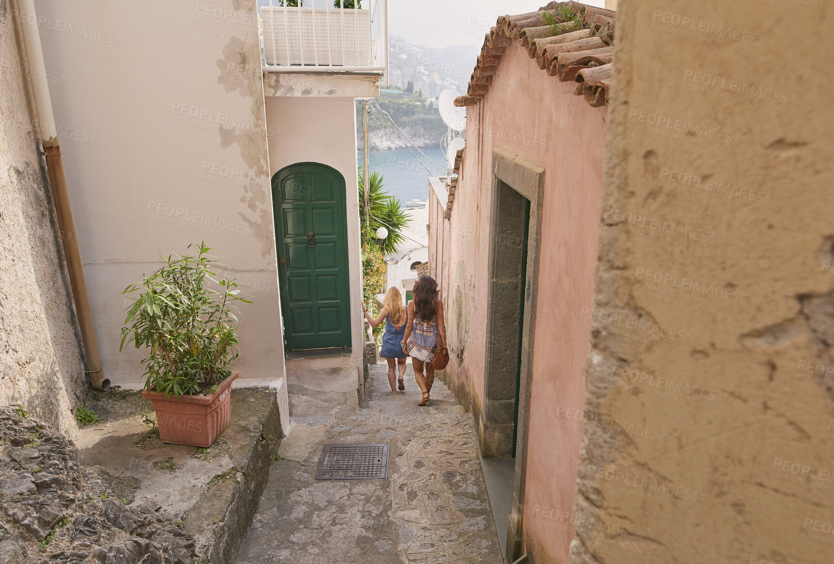 Buy stock photo Holiday, travel and walking with friends in old city together for adventure, journey or sightseeing. Back, building and tourism with women outdoor in historic town to discover or explore culture