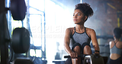 Buy stock photo Woman, fitness and rowing machine in gym with exercise, endurance and strength training for wellness. Active, African person and workout in health club with ergometer, equipment and cardio challenge.