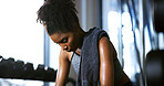 Sweat, tired and woman in gym, exercise and finish training with health break for fitness recovery. Sports club, thinking and exhausted African bodybuilder with fatigue, wellness or rest to cool down
