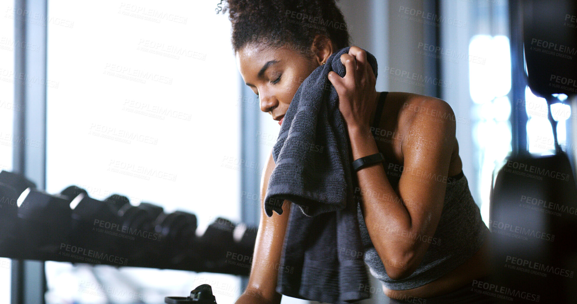 Buy stock photo Fitness, towel or tired woman in gym, sweat and intense training recovery for wellness to cool down. Break, wipe and black person with fatigue after exercise challenge in club, bodybuilder or relax