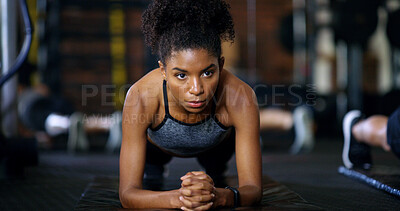 Buy stock photo Woman, fitness and plank in gym with workout, endurance and training for wellness in health club. Serious, female person and balance on floor with stability, strength challenge and exercise for abs.