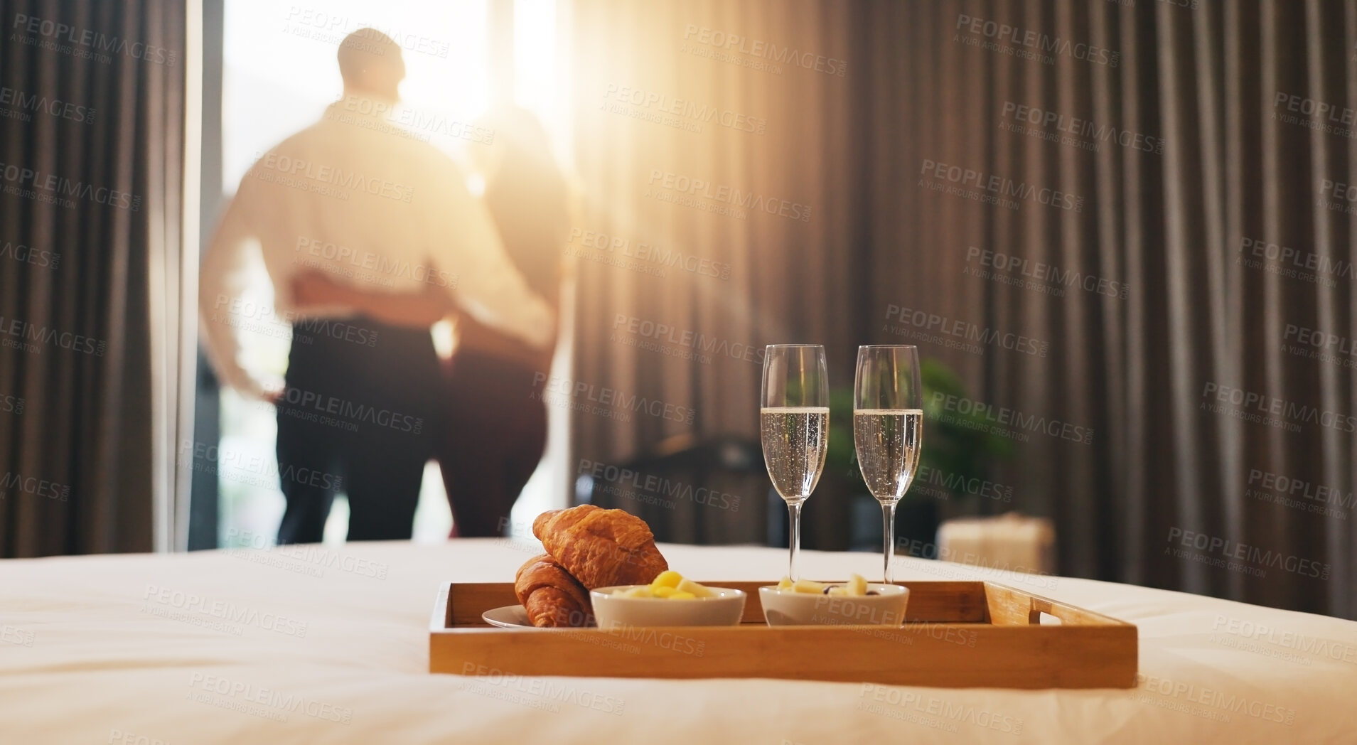 Buy stock photo Champagne, breakfast and couple in hotel with room service for anniversary holiday, getaway or vacation. Curtains, sparkling wine and back of people by window for view with morning meal on trip.