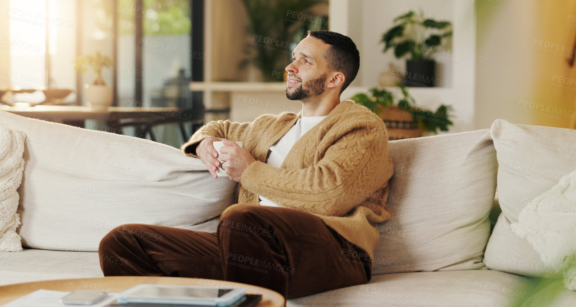 Buy stock photo Happy man, relax and daydream with coffee in lounge, chill and comfortable on weekend or reflection. Thinking, person and smile with good memory, nostalgia and thoughtful with caffeine drink in house