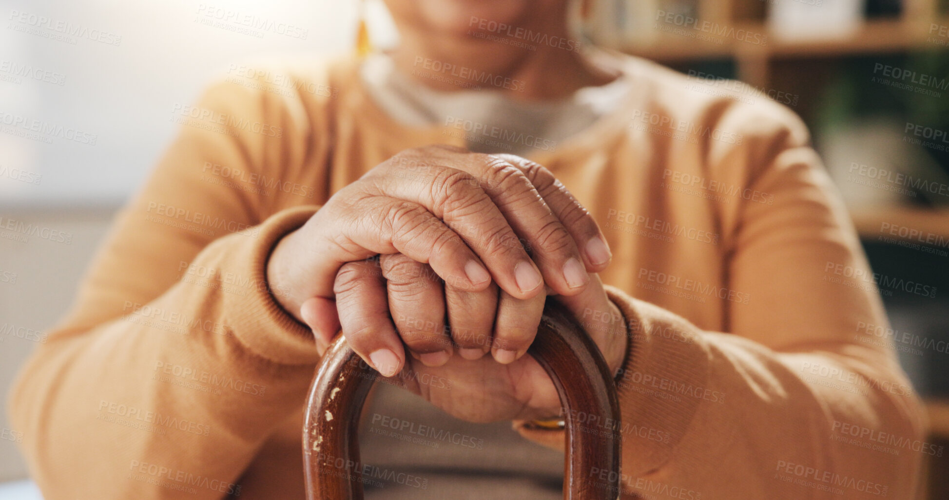 Buy stock photo Hands, old person and walking stick in home living room for assistance, balance or retirement. Cane, healthcare or wellness and senior woman with disability in apartment for break, relax or weekend