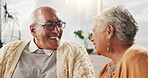 Old couple, love and relax with smile in house, retirement and laugh with partner on weekend or chat. Elderly people, bonding and comfortable with spouse, happy and funny conversation in living room