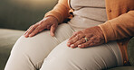 Hands, retirement and senior woman on sofa in living room of home for contemplation or wellness. Break, thinking and waiting with old person in apartment lounge for memories, nostalgia or relax