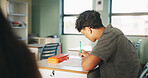 Student, boy and writing in classroom with high school education, assignment and draft english essay. Teenager, notes and learning in academy with knowledge, language assessment or skill development.
