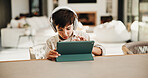 Homework, headphones and child in home with tablet, online activity and project on academic app. Homeschool, tech and boy in kitchen with website, digital lesson or assessment in remote education