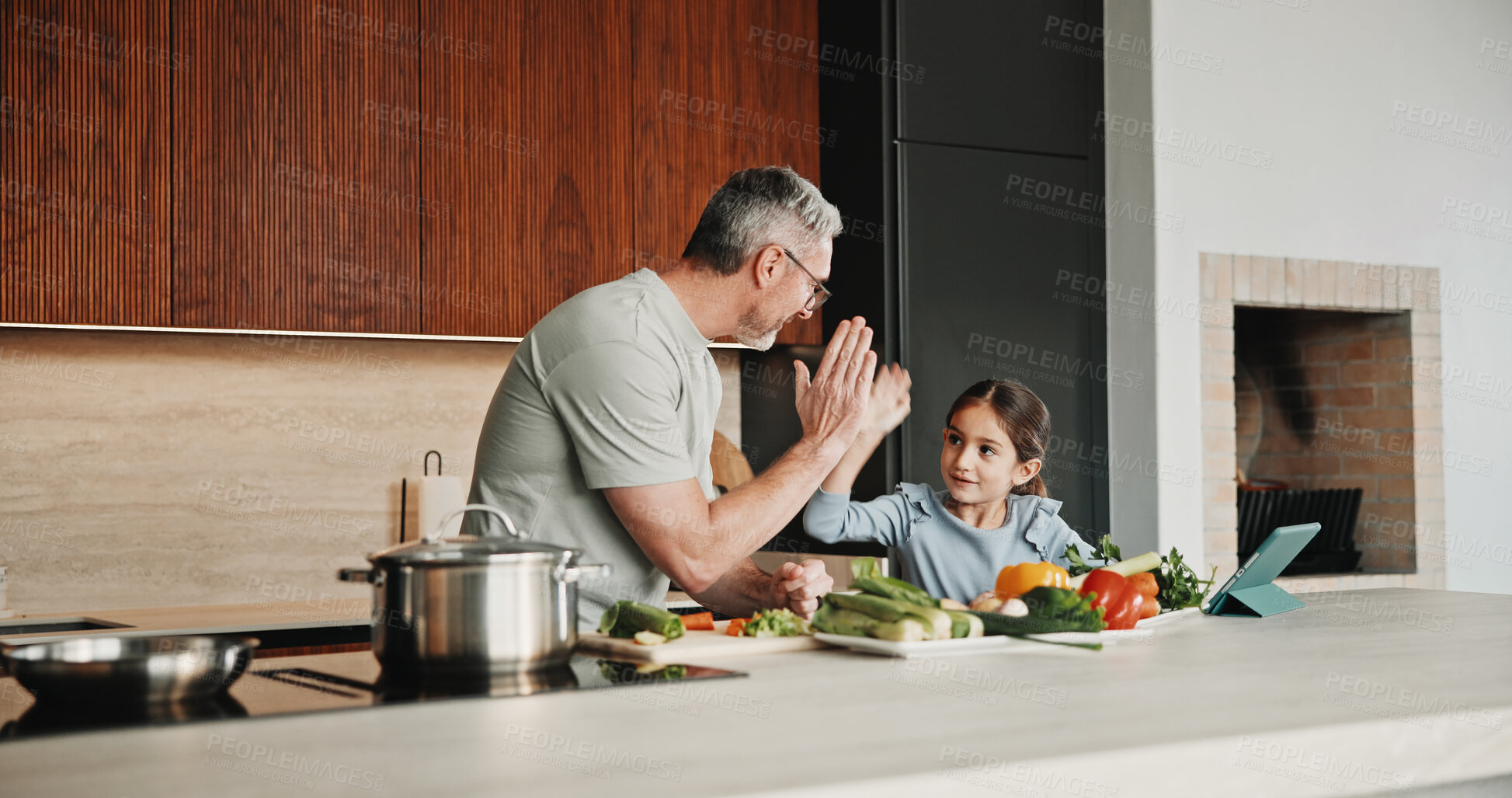 Buy stock photo Father, girl and high five with tablet, cooking and meal prep in home for education. Dad, child or learning recipe with tech, development or celebration in kitchen with tutorial or support for dinner
