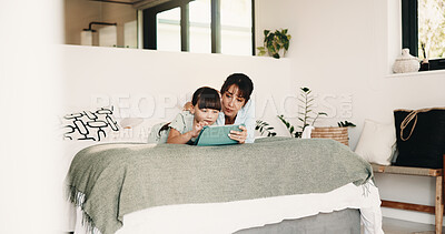 Buy stock photo Mother, child and typing in bedroom with tablet, assistance and play knowledge game for development. Family, mom and daughter learning in home with tech, parent help or educational gaming for growth.
