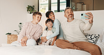 Buy stock photo Selfie, happy and family on bed in home for bonding, love and memory together on weekend. Smile, relax and parents with children for photography picture in bedroom for social media post in house.