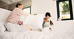 Happy, children and fight with pillow in bedroom for fun, playful interaction and friendly battle. Smile, siblings and playing with cushion, morning activity and funny games for weekend break in home