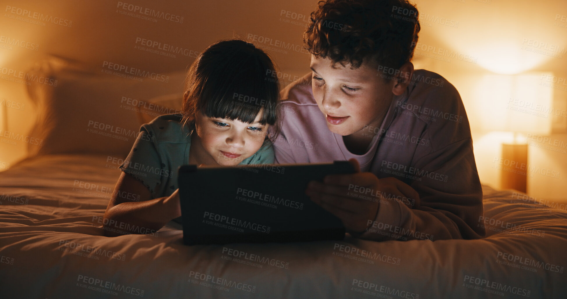 Buy stock photo Night, relax and kids with tablet in bedroom for game, streaming cartoon or watch show on internet. Tech, siblings and children on bed at home for movie, subscription service and entertainment